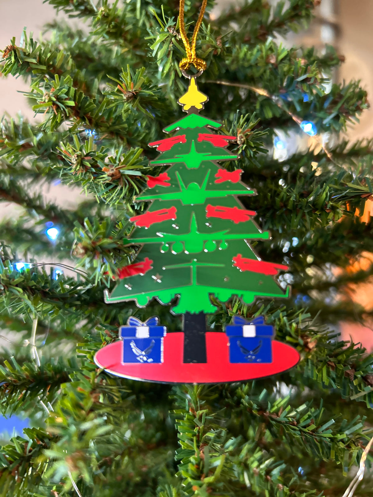 U.S. Air Force Christmas tree ornament made of aircraft silhouettes with a gold jet topper and Air Force gift boxes